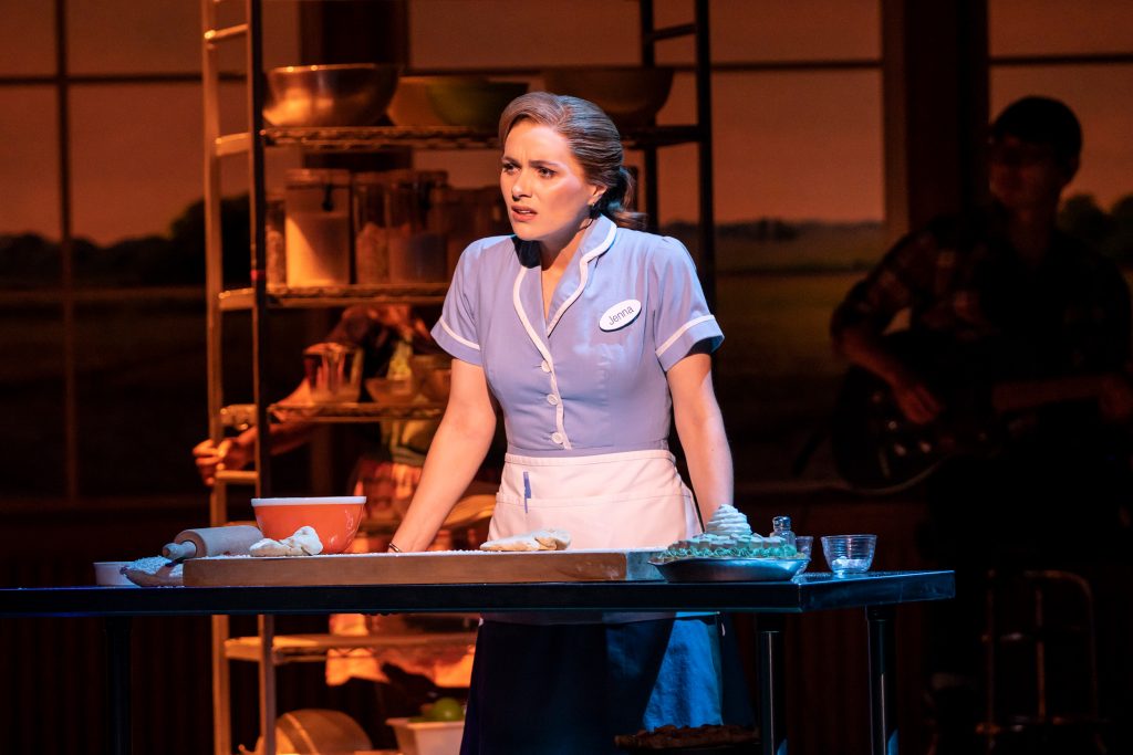 Photo of a waitress leaning on a table